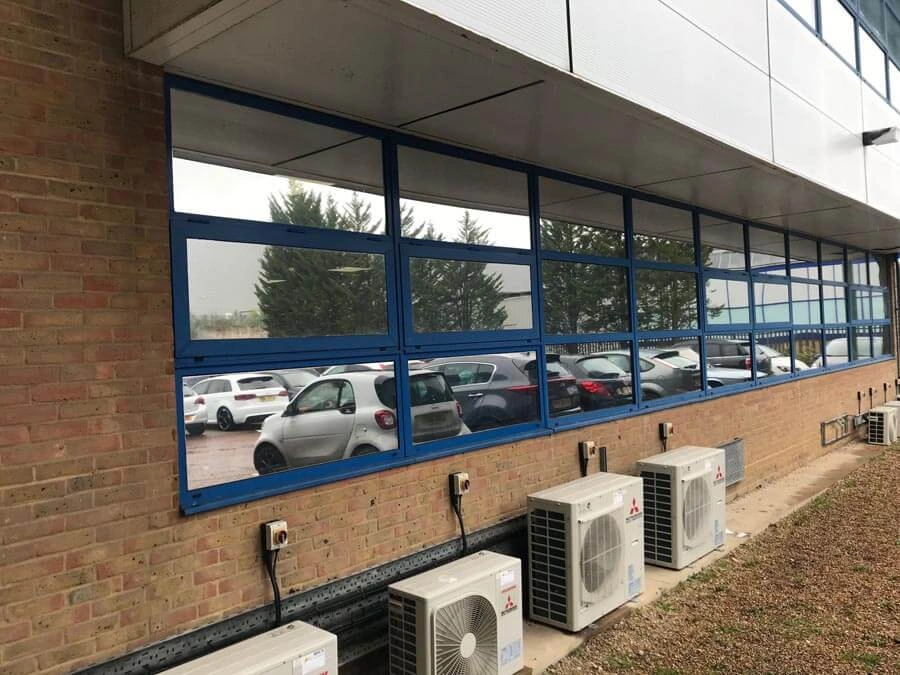 Reflective solar window film installed on commercial glazing.